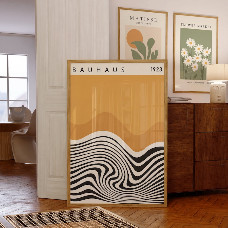 May include: A framed print with the text "BAUHAUS 1923" and a graphic design of a black and white wavy pattern on a yellow background.