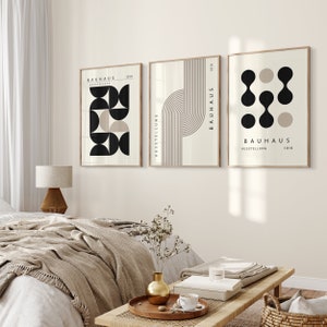 May include: Three minimalist art prints with geometric shapes and the text "Bauhaus Ausstellung 1919" in black and white on a beige background.