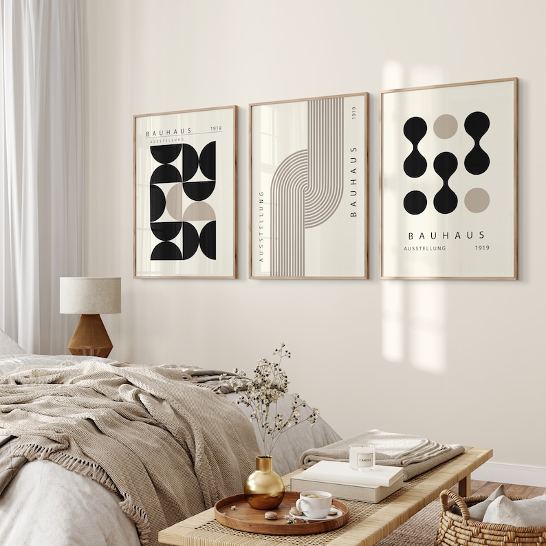 May include: Three minimalist art prints with geometric shapes and the text "Bauhaus Ausstellung 1919" in black and white on a beige background.