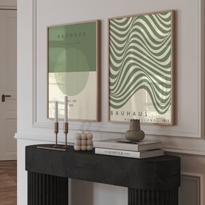 May include: Two framed prints with a green and white geometric design. The prints feature the text "Bauhaus Ausstellung" and the dates "Juli-Sep 1923" and "1923".