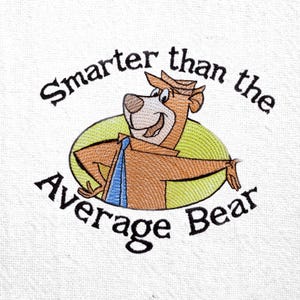 May include: Embroidered design featuring a cartoon bear in a hat and tie, inside a green oval. Text above reads "Smarter than the", and below reads "Average Bear" in black script. The bear is brown with a blue tie.