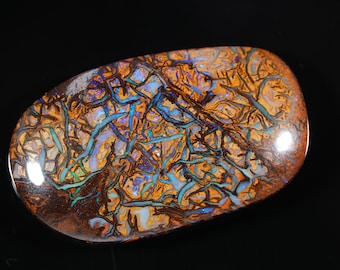May include: A polished, oval-shaped opal with a complex pattern of brown, orange, and blue veins. The gemstone has a glossy surface and is set against a black background. The opal's unique internal structure creates a striking visual effect.