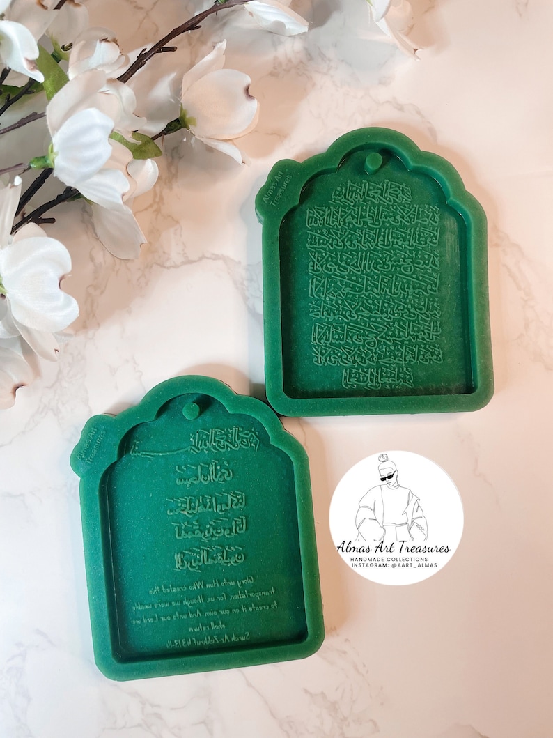 May include: Two green silicone molds for resin casting. The molds are shaped like a traditional Islamic archway with Arabic calligraphy inside. The text in the molds reads "Almas Art Treasures Handmade Collections Instagram: @art_almas".