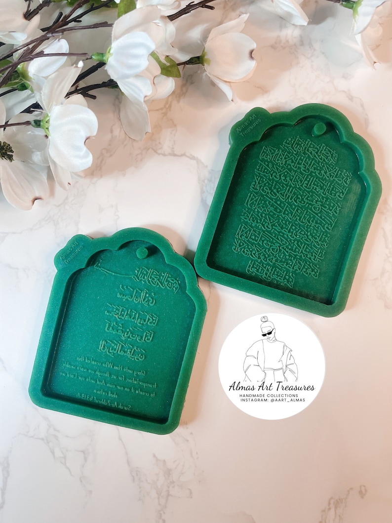 May include: Two green silicone molds for resin casting. The molds are shaped like a traditional Islamic prayer rug with Arabic calligraphy. The text in the molds reads "Almas Art Treasures Handmade Collections Instagram: @Aart_Almas".