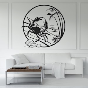 May include: Black and white wall art featuring a crab in a circular frame. The design includes a beach scene with a crab, seashells, and palm trees. The artwork is mounted on a white wall above a white sofa.