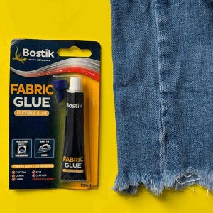 May include: A tube of Bostik Fabric Glue, a flexible glue for fabrics like cotton, denim, felt, leather, and linen. The tube is 20ml and is shown on a yellow background with a piece of blue denim.