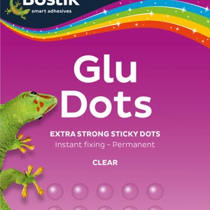 May include: A pack of clear, extra strong sticky dots from Bostik. The pack features a green gecko and the text "Glu Dots" and "Instant fixing - Permanent".