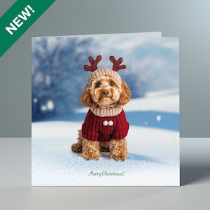 May include: A Christmas card showing a dog in a red sweater and reindeer antlers, set in a snowy scene. The card says "Merry Christmas!" in green. A green banner in the top left corner reads "NEW!"