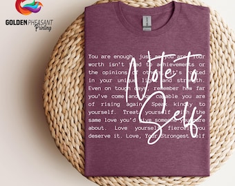 May include: A maroon t-shirt with white text that reads "You are enough, just as you are. Your worth isn't tied to achievements or the opinions of others. It's rooted in your unique light and strength. Even on tough days, remember how far you've come and how capable you are of rising again. Speak kindly to yourself. Treat yourself with the same love you'd give someone you care about. Love yourself fiercely. You deserve it. Love, Your Strongest Self."