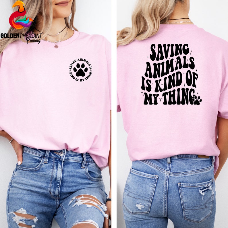 May include: A pink t-shirt with a paw print and the text "Saving Animals is Kind of My Thing" on the front and the same text in a larger font on the back.