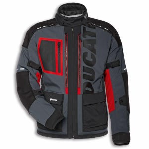May include: Grey and black motorcycle jacket with red detailing and the word "DUCATI" printed vertically. It has multiple pockets, zips, and reflective stripes. The jacket features a high collar and is designed for motorcycle use.
