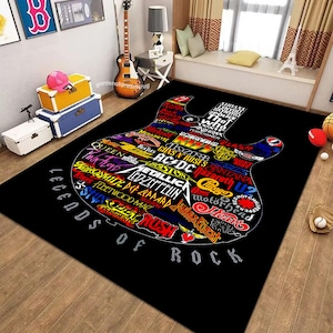 May include: Black and white guitar-shaped rug with the words "Legends of Rock" at the bottom. The guitar is filled with the names of famous rock bands, including Queen, AC/DC, Metallica, Led Zeppelin, and Rush.