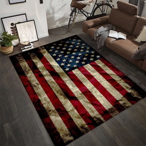 May include: A vintage-style American flag rug with red, white, and blue colors. The rug has a distressed look, with faded colors and a slightly wrinkled texture.
