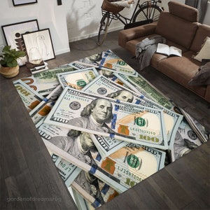 May include: A rug featuring a close-up of a pile of US $100 bills. The bills are arranged in a random pattern, with some bills folded and others unfolded. The rug is made of a soft, durable material and is perfect for adding a touch of luxury to any room.