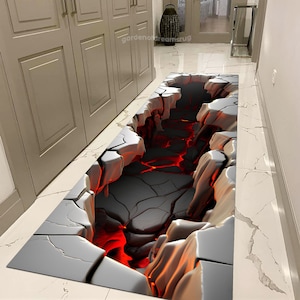 May include: A gray and white rug with a 3D design of cracked earth revealing a glowing red lava flow underneath. The rug is placed on a white tiled floor in a hallway.