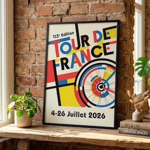 May include: A framed poster for the 113th edition of the Tour de France, featuring a colorful geometric design with the words "TOUR DE FRANCE" in bold letters. The poster includes a bicycle wheel graphic and the dates 4-26 Juillet 2026.