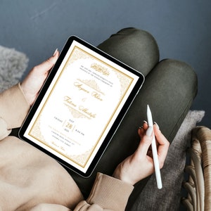 May include: A digital invitation on a tablet screen with a gold and white design. The invitation reads "We are honored to request your presence at the Nikah Ceremony of Ayyan Khan & Fatima Mustafa. Friday, July 28, 2023, 8:00 PM. The Grand Hall, 1234 Country Road, City, Country".