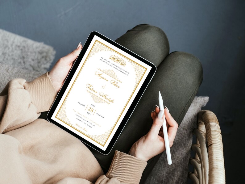 May include: A digital invitation on a tablet screen with a gold and white design. The invitation reads "We are honored to request your presence at the Nikah Ceremony of Ayyan Khan & Fatima Mustafa. Friday, July 28, 2023, 8:00 PM. The Grand Hall, 1234 Country Road, City, Country".