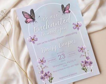 May include: Baby shower invitation with a soft blue and lavender watercolor background. The invitation features butterflies, floral accents, and the text "We are Enchanted to meet you" and details for Daisy Cooper's baby shower.