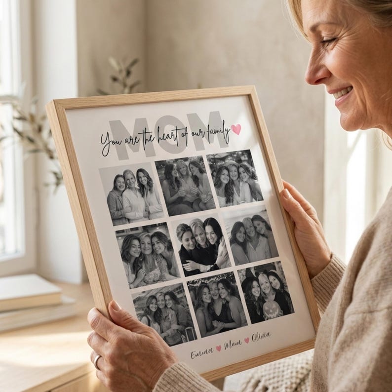 May include: A framed photo collage with a light wood frame. The collage features nine black and white photos. The word "MOM" is at the top, with the phrase "You are the heart of our family" and names below.