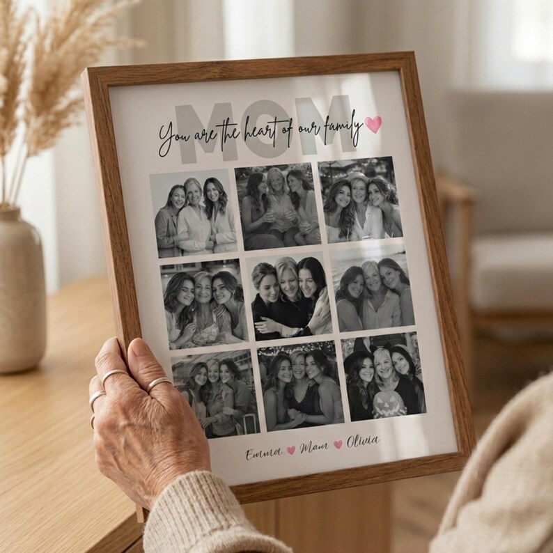 May include: A framed photo collage with a wooden frame. The collage features nine black and white photos of women. The text "MOM" is at the top, with "You are the heart of our family" below it. The names "Emma", "Mom", and "Olivia" are at the bottom.