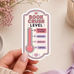 May include: A die-cut sticker featuring a pink thermometer graphic labeled BOOK CRUSH LEVEL. The scale includes four levels: Emotionally Attached, Obsessed, Invested, and Curious, each marked with a small heart icon in pink or purple colors.