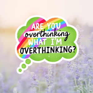 May include: A sticker with the text "ARE YOU overthinking WHAT I'M OVERTHINKING?" in a green thought bubble with a rainbow and white text. The background is a field of purple flowers.