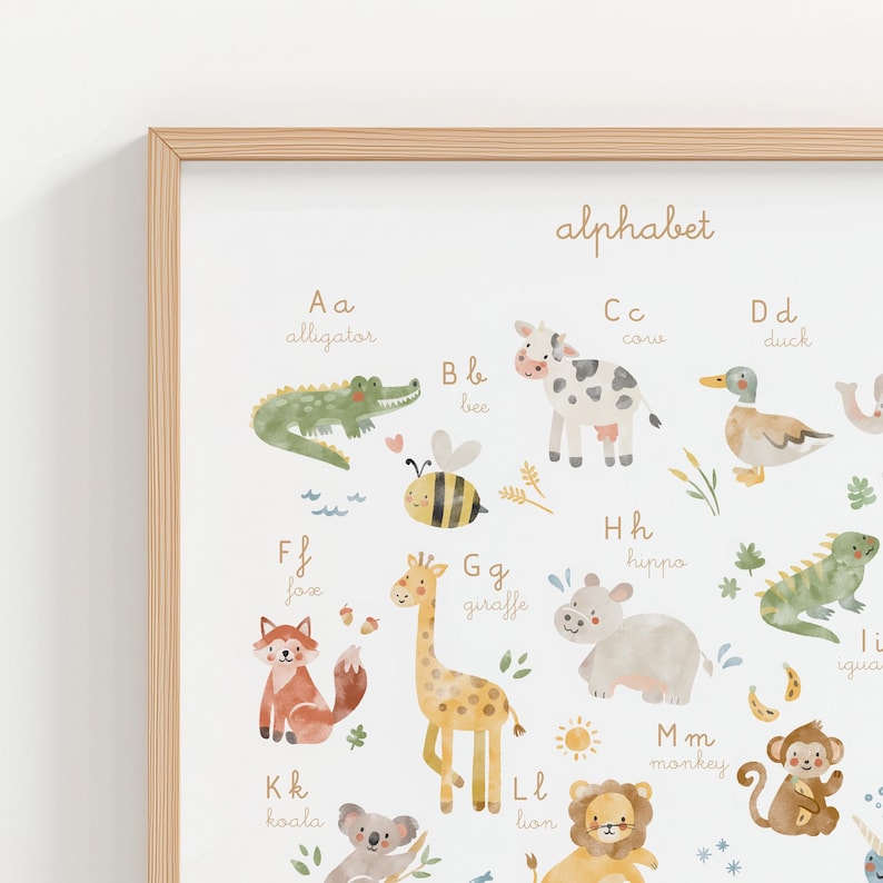 Close-up macro shot of the watercolor alphabet print showing high-quality texture. Visible details of letters A to E with cute illustrated alligator, bee, cow, duck, and elephant. Elegant script typography for nursery learning.
