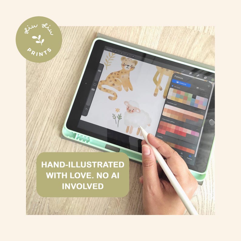 Graphic artist hand-drawing cute watercolor baby animals on a digital tablet with a stylus pen. Features a leopard and sheep illustration with a color palette. Text block reads: "Hand-illustrated with love. No AI involved." Original nursery decor art process.