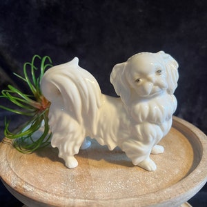 Vintage 4.5”  porcelain Pekingese dog figurine; unmarked; white porcelain dog figurine