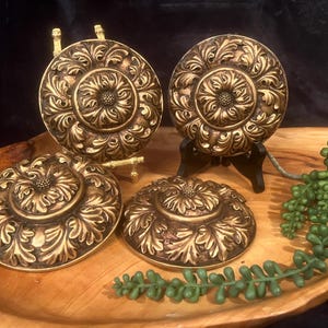 Ornate round gold tone medallions; Sold Individually