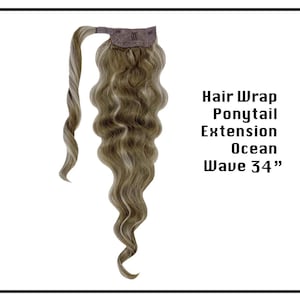 May include: A long, wavy, light brown and blonde hair extension with a brown hair wrap. The extension is 34 inches long and has an ocean wave texture. The text "Hair Wrap Ponytail Extension Ocean Wave 34"" is visible in the image.