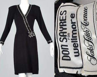 Schwarzes, mittellanges, strickiges Etuikleid im Vintage-Stil der 1980er Jahre mit silbernen Pailletten, Schleife und V-Ausschnitt.