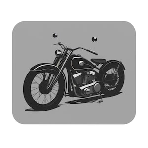 May include: A black vintage motorcycle with a chrome engine and a single seat. The motorcycle is on a gray background.