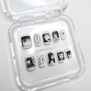 handmade matte press-on nails with a gothic Halloween theme. Each nail features black and white manga illustrations inspired by Junji Ito's Tomie, printed in comic panel style. Nails are sharp coffin shape, with high contrast matte finish and eerie graphic details. Ideal for cosplay, horror-themed birthday party, Halloween costumes or comic conventions. Customizable design by wubunails for gothic lovers. A perfect glue-on faux acrylic nail set for fans of Japanese horror and manga.