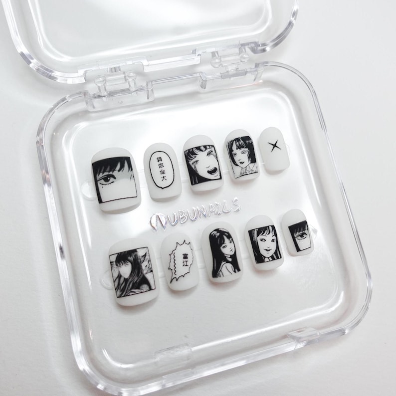 handmade matte press-on nails with a gothic Halloween theme. Each nail features black and white manga illustrations inspired by Junji Ito's Tomie, printed in comic panel style. Nails are sharp coffin shape, with high contrast matte finish and eerie graphic details. Ideal for cosplay, horror-themed birthday party, Halloween costumes or comic conventions. Customizable design by wubunails for gothic lovers. A perfect glue-on faux acrylic nail set for fans of Japanese horror and manga.
