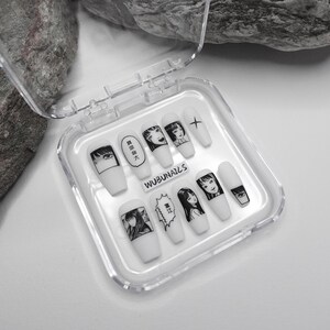 handmade matte press-on nails with a gothic Halloween theme. Each nail features black and white manga illustrations inspired by Junji Ito's Tomie, printed in comic panel style. Nails are sharp coffin shape, with high contrast matte finish and eerie graphic details. Ideal for cosplay, horror-themed birthday party, Halloween costumes or comic conventions. Customizable design by wubunails for gothic lovers. A perfect glue-on faux acrylic nail set for fans of Japanese horror and manga.
