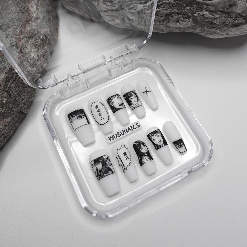 handmade matte press-on nails with a gothic Halloween theme. Each nail features black and white manga illustrations inspired by Junji Ito's Tomie, printed in comic panel style. Nails are sharp coffin shape, with high contrast matte finish and eerie graphic details. Ideal for cosplay, horror-themed birthday party, Halloween costumes or comic conventions. Customizable design by wubunails for gothic lovers. A perfect glue-on faux acrylic nail set for fans of Japanese horror and manga.