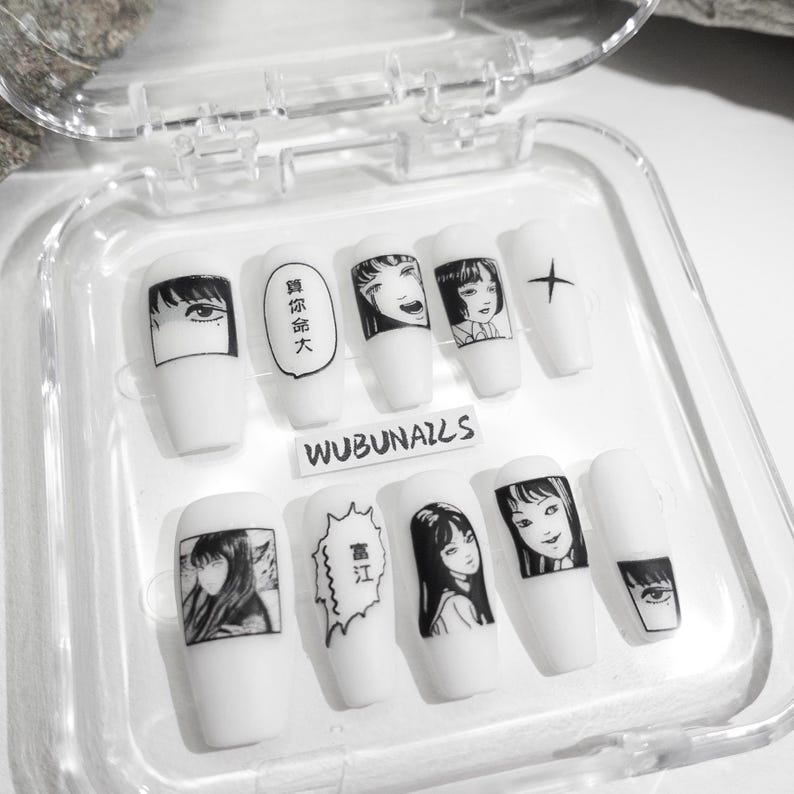 handmade matte press-on nails with a gothic Halloween theme. Each nail features black and white manga illustrations inspired by Junji Ito's Tomie, printed in comic panel style. Nails are sharp coffin shape, with high contrast matte finish and eerie graphic details. Ideal for cosplay, horror-themed birthday party, Halloween costumes or comic conventions. Customizable design by wubunails for gothic lovers. A perfect glue-on faux acrylic nail set for fans of Japanese horror and manga.