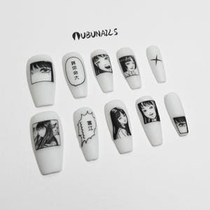handmade matte press-on nails with a gothic Halloween theme. Each nail features black and white manga illustrations inspired by Junji Ito's Tomie, printed in comic panel style. Nails are sharp coffin shape, with high contrast matte finish and eerie graphic details. Ideal for cosplay, horror-themed birthday party, Halloween costumes or comic conventions. Customizable design by wubunails for gothic lovers. A perfect glue-on faux acrylic nail set for fans of Japanese horror and manga.