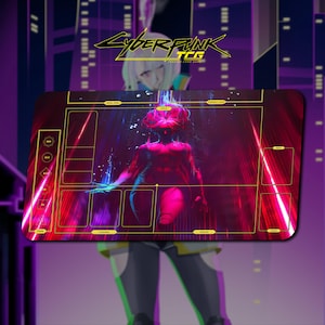 May include: A rectangular playmat for the Cyberpunk TCG featuring a dark red and purple graphic of a central figure. The mat includes yellow outlined zones for cards, dice, and game elements, with text labels such as Field, Rival Dice, and Friendly Dice.