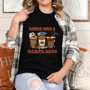 May include: A black t-shirt with a graphic of coffee cups and the text "Pumpkin Spice & Childbirth Advice".