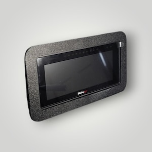May include: A black rectangular digital display screen with a textured black frame. The screen is turned off, and the brand name "Holley" is visible at the bottom. The device is mounted on a white surface.