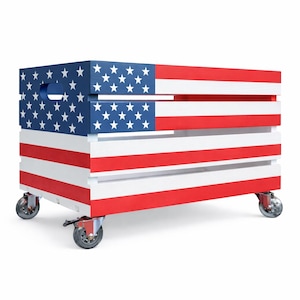 May include: A rectangular wooden storage crate painted with the American flag design. The crate features a blue top with white stars and red and white stripes. It has a handle and is mounted on four caster wheels.