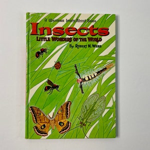 May include: A Whitman Learn About Book titled "Insects: Little Wonders of the World" by Robert N. Webb. The book cover features colorful illustrations of various insects, including a ladybug, a caterpillar, a moth, and a lacewing.