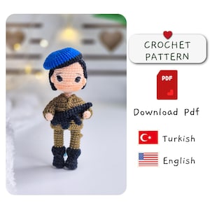 May include: Crochet pattern for an amigurumi soldier doll wearing a blue beret, brown uniform, and holding a black rifle. The pattern is available in Turkish and English languages. Download PDF.