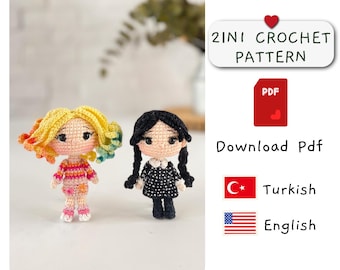 May include: Two crocheted dolls, one with yellow and rainbow hair and a striped shirt, the other with black hair and a black and white dress. The dolls are standing on a white surface. The text "2INI CROCHET PATTERN" is in a red heart-shaped box. The text "Download Pdf" is below the box. A Turkish flag and an American flag are below the text. The text "Turkish" is next to the Turkish flag and the text "English" is next to the American flag.