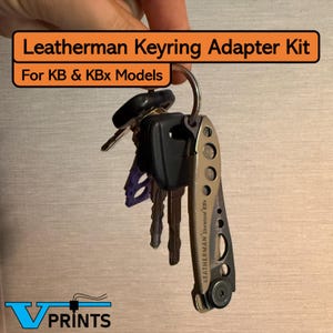 May include: A Leatherman Keyring Adapter Kit for KB & KBx Models. The image shows a keyring with keys and a Leatherman Skeletool KBx multi-tool. The text "Leatherman Keyring Adapter Kit" and "For KB & KBx Models" is visible in the image.