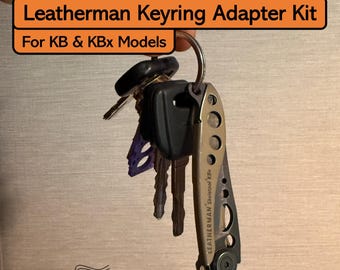 May include: A Leatherman Keyring Adapter Kit for KB & KBx Models. The image shows a keyring with keys and a Leatherman Skeletool KBx multi-tool. The text "Leatherman Keyring Adapter Kit" and "For KB & KBx Models" is visible in the image.