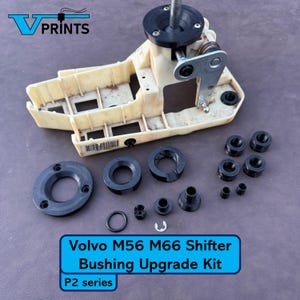 May include: A beige and black Volvo M56 M66 Shifter Bushing Upgrade Kit, P2 series. The kit includes various black bushings, a metal lever, and a plastic housing. The text "VPRINTS" is in the upper left corner.